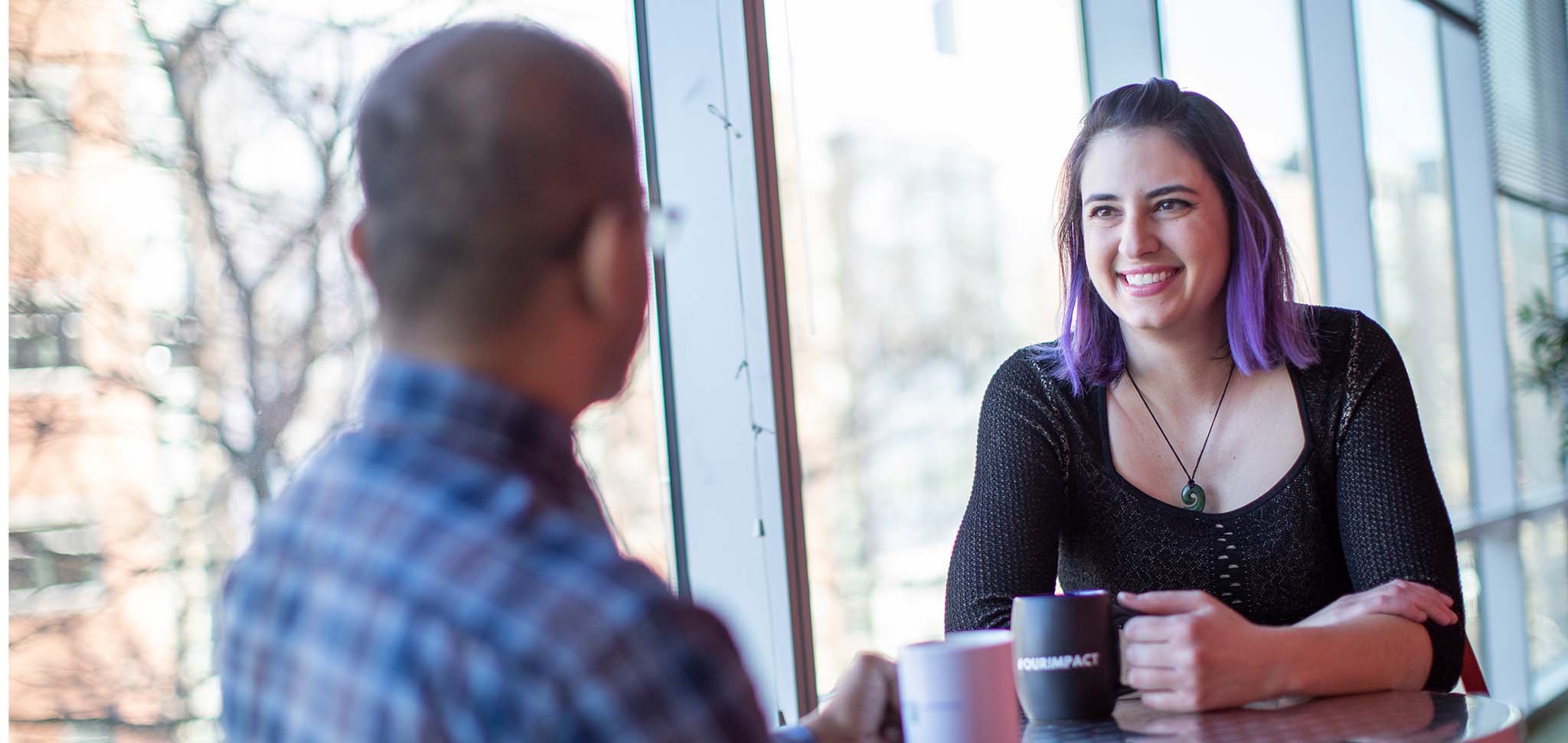 Photo of two employees having a conversation