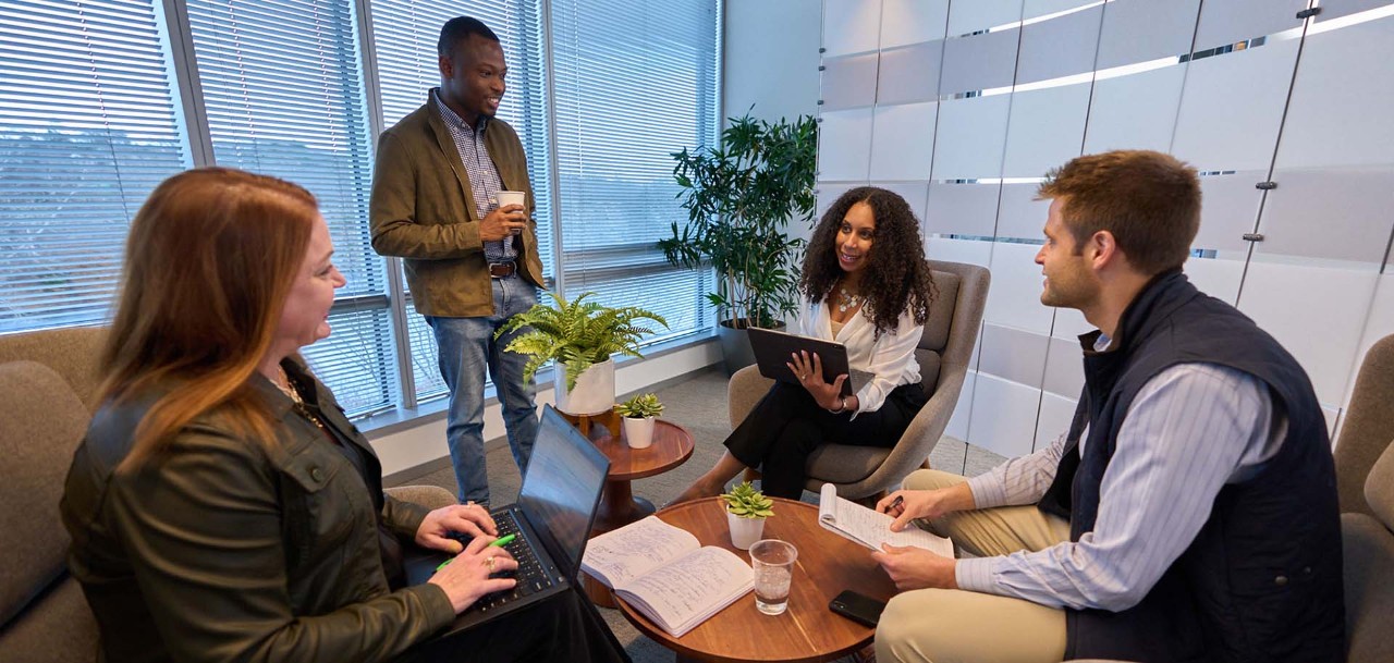 Two Biogen employees working together on a laptop in an office